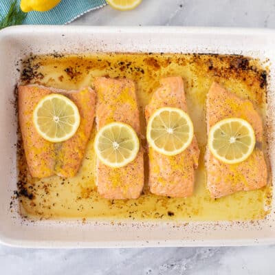 Four pieces of Baked Lemon Salmon in a baking dish.