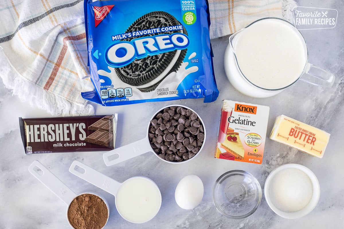 Ingredients to make Chocolate Satin Pie including Oreo cookies, heavy cream, milk, butter, Gelatin, sugar, water, egg, cocoa powder, chocolate chips and chocolate bar.