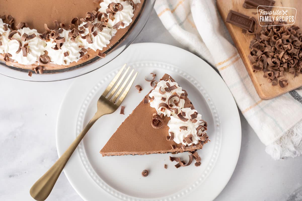 Top view of a slice of Chocolate Satin Pie on a plate with a fork.
