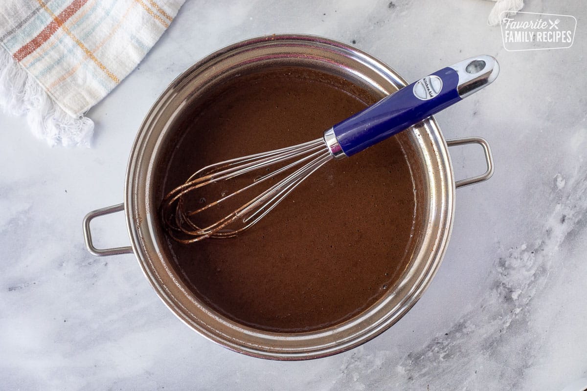 Whisked together chocolate ingredients in a pan for Chocolate Satin Pie filling.