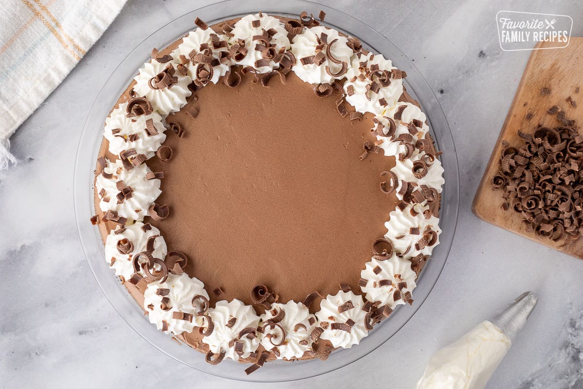 Decorated Chocolate Satin Pie with whipped cream and chocolate curls around the border.
