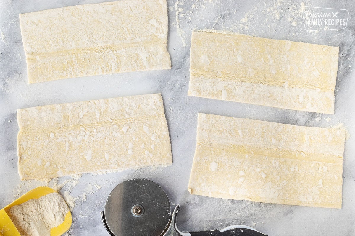 Four rectangle shaped puff pastry sheets for Sausage Rolls.