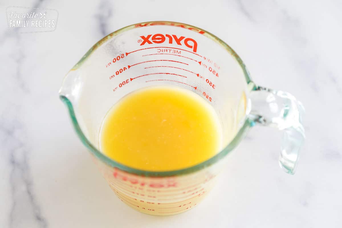 pineapple curd in a glass measuring cup