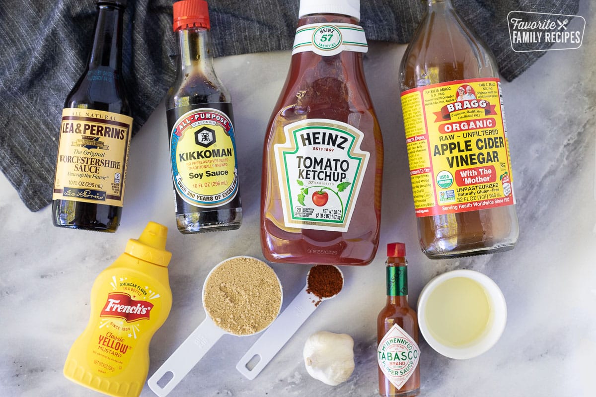 Ingredients to make Homemade BBQ Sauce including, Worcestershire sauce, soy sauce, ketchup, apple cider vinegar, mustard, brown sugar, cayenne pepper, garlic, tabasco and oil.