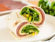 An italian sandwich wrap cut in half and stacked on top of each other