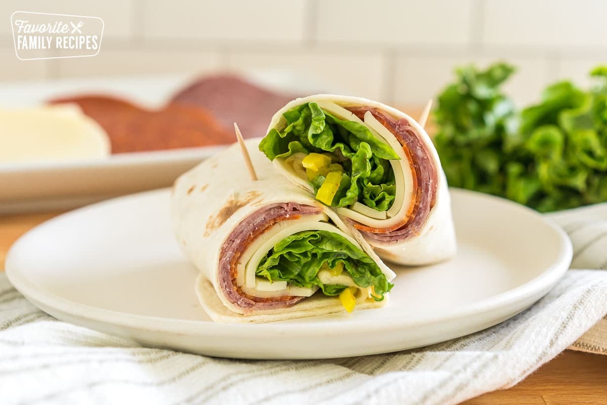 An italian sandwich wrap cut in half and stacked on top of each other