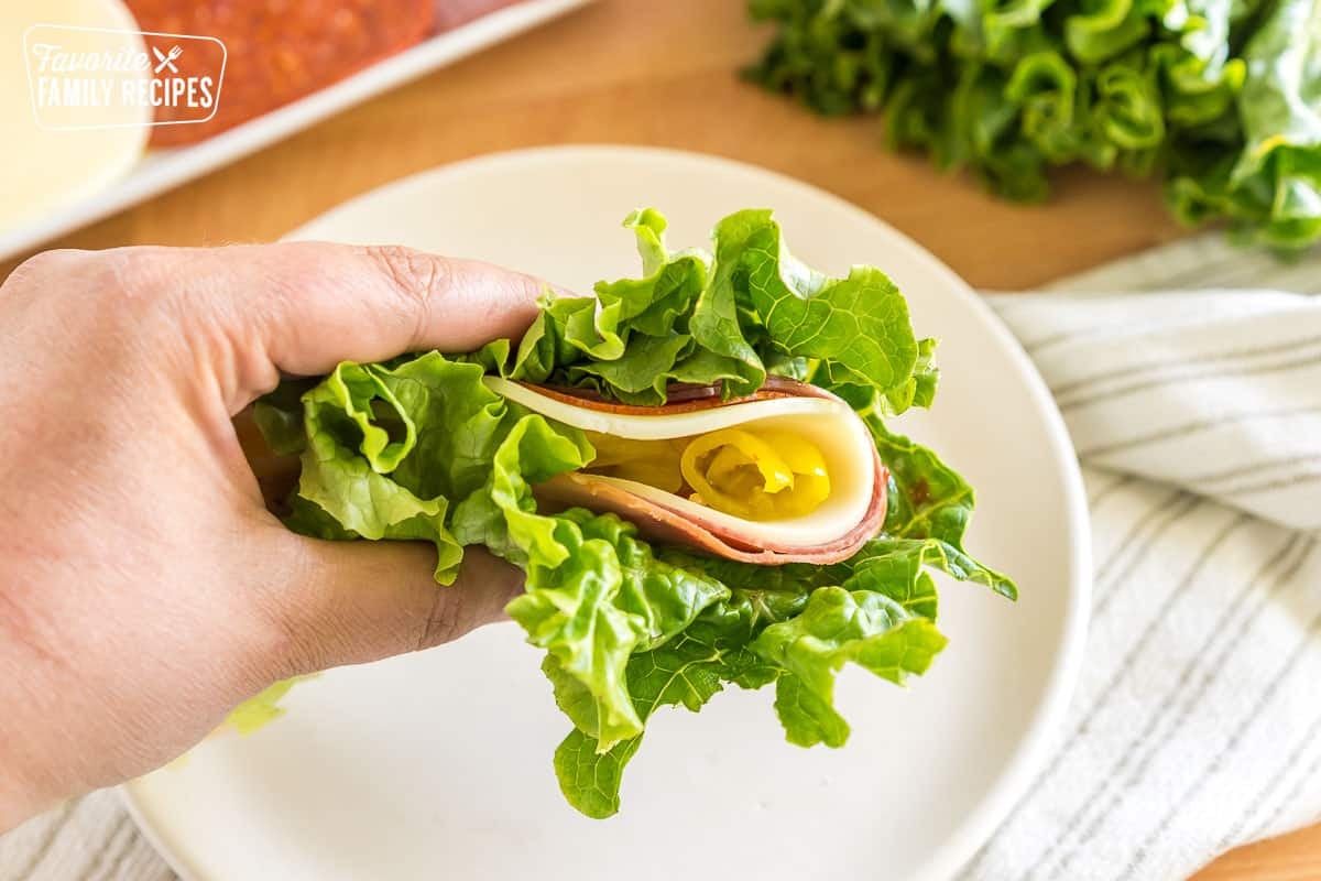 A lettuce wrap with italian meats, cheese, and banana peppers