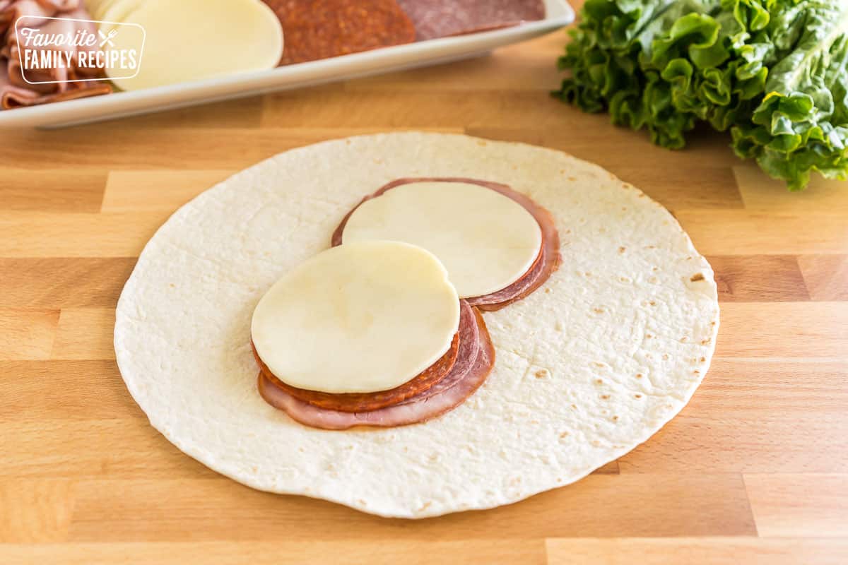 a tortilla with italian meats and provolone cheese