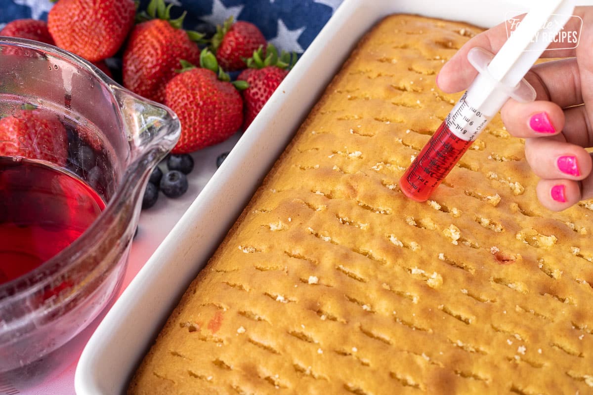 Injecting red Jello into a cake for 4th of July Cake.