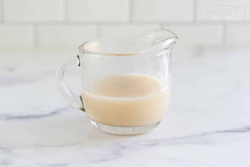 Coconut cream sauce in a small pitcher