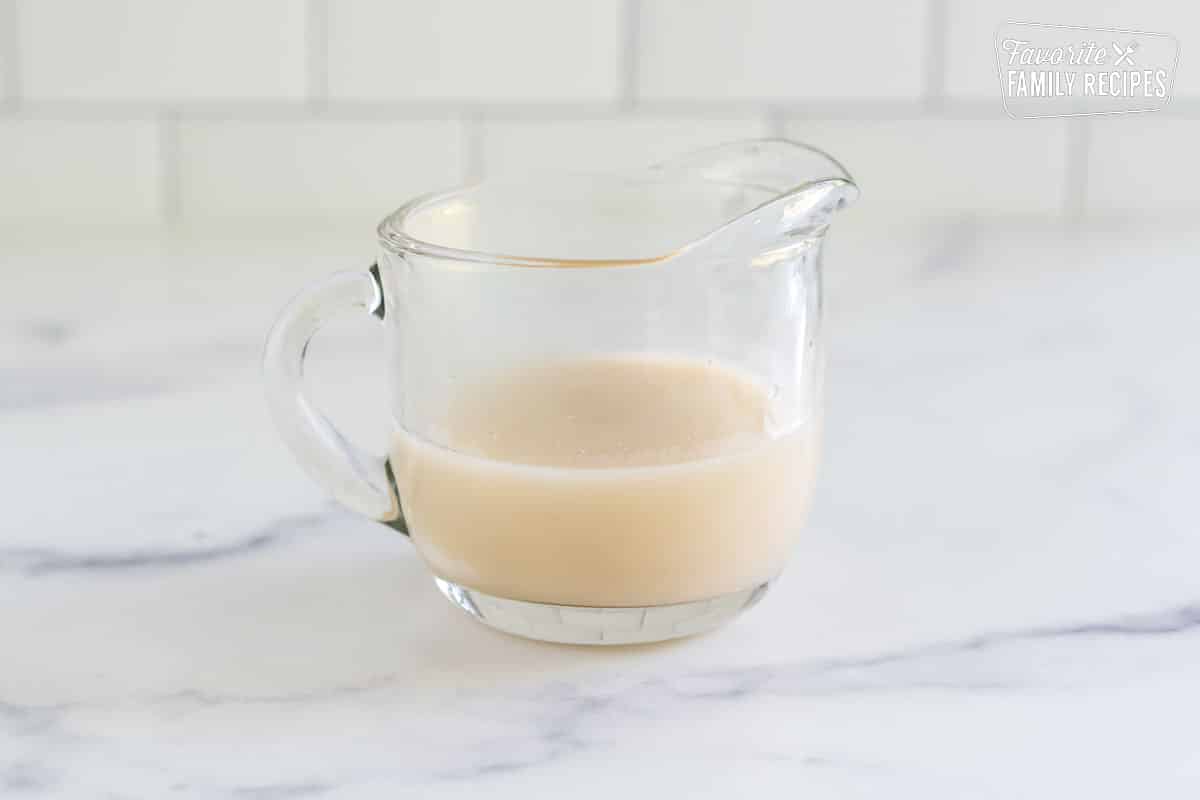 Coconut cream sauce in a small pitcher