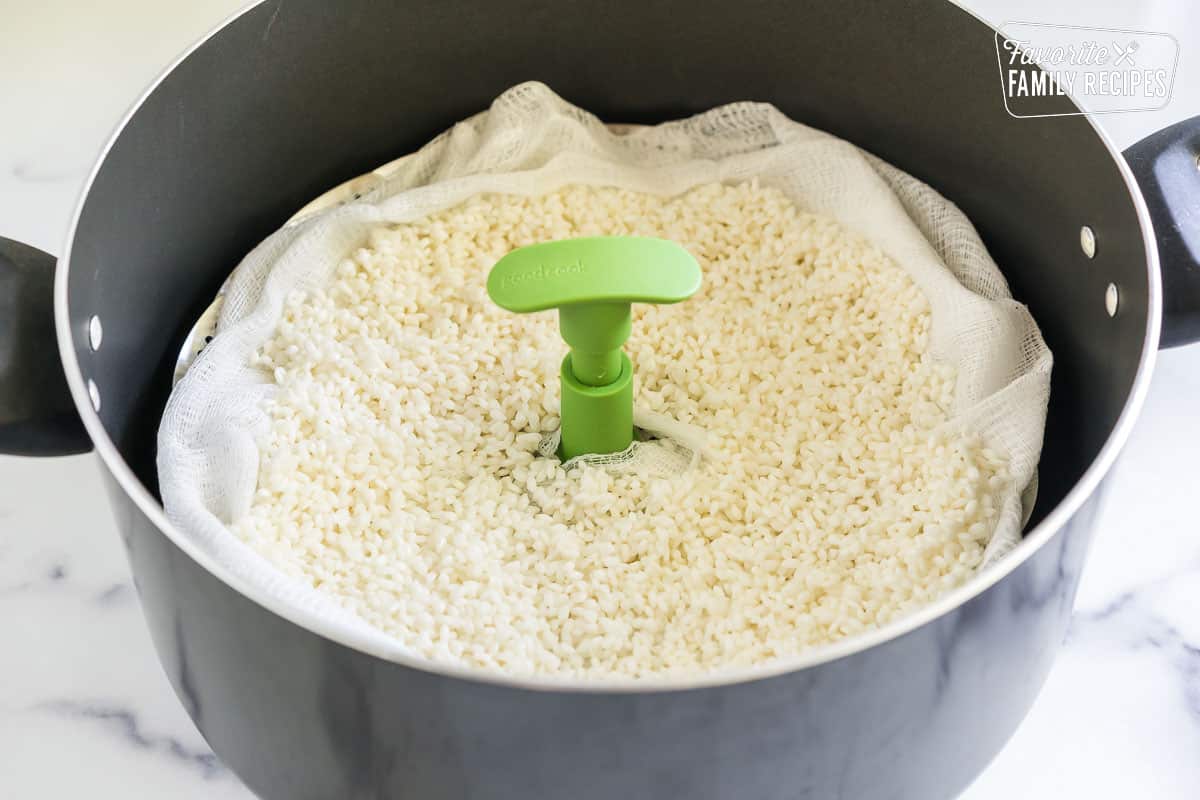 Rice on a steamer tray in a large pot