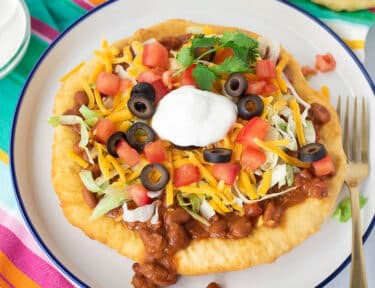 Navajo Taco with chili, lettuce, tomatoes, cheese, olives and sour cream.
