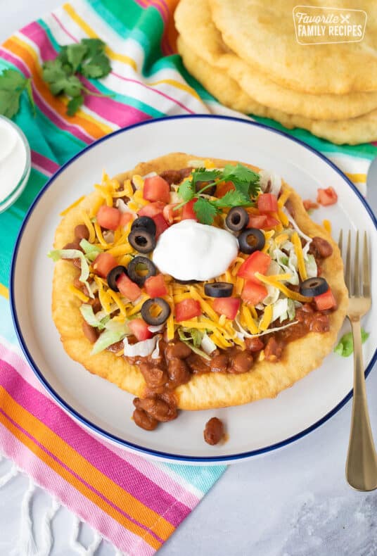Navajo Taco with chili, lettuce, tomatoes, cheese, olives and sour cream.