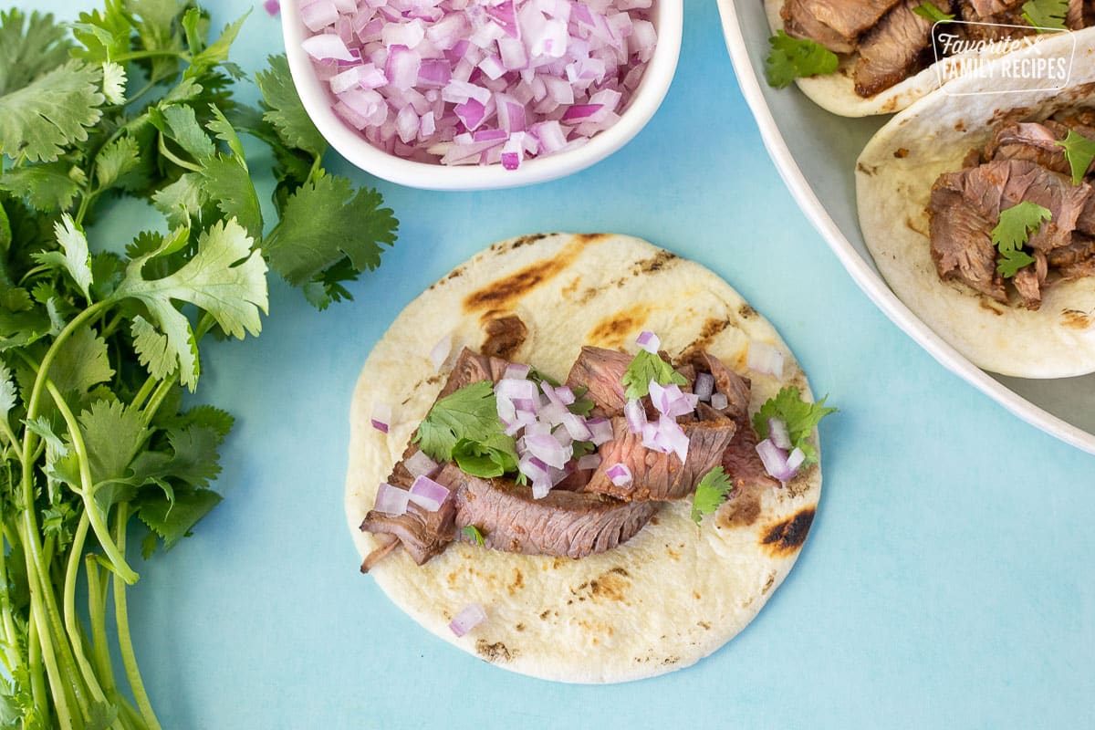 Steak, red onion and cilantro on a Sweet Taco tortilla.