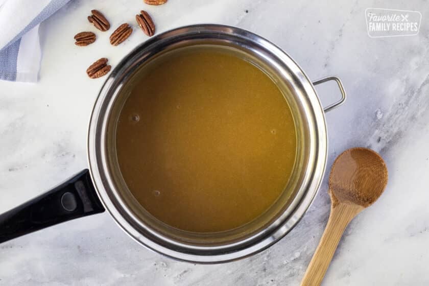 Sauce pan of heavy cream combined with sugars to make Pecan Pralines.