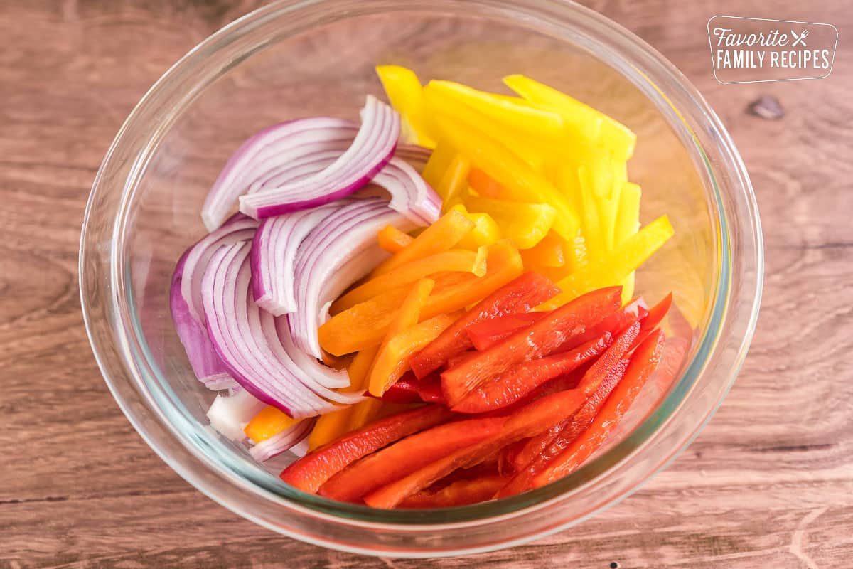 thinly sliced peppers and onions in a bowl