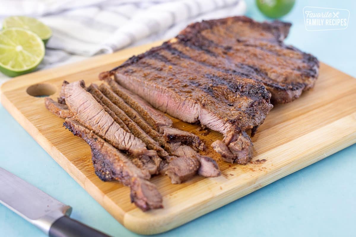 Slicing steak on a cutting board for Street Tacos.