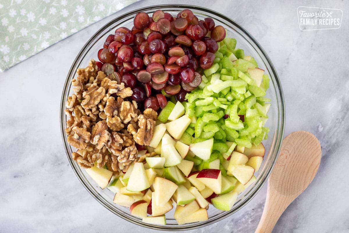 Glass bowl of grapes, apples, celery and walnuts for Waldorf Salad.