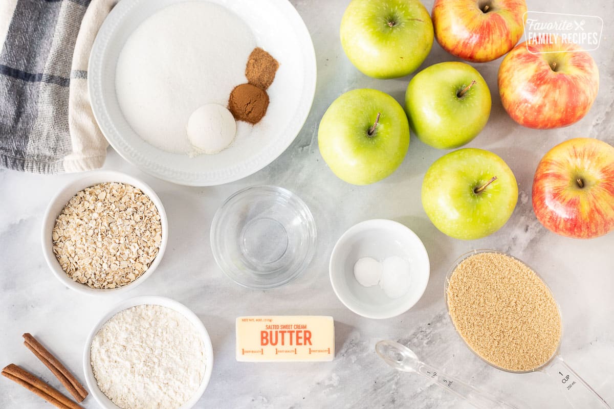Apple Crisp ingredients including apples, sugar, cinnamon, nutmeg, flour, water, baking soda, baking powder, almond extract, brown sugar, oats and butter.