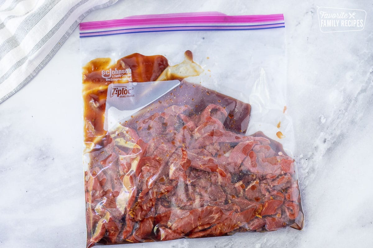 Ziplock bag with sliced beef and marinade for Beef Stir Fry.
