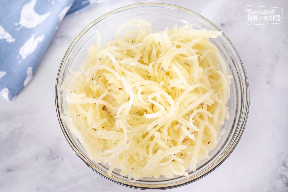 Bowl with grated potatoes for making Hash Browns.