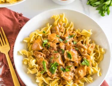 Chicken Paprikash in a bowl topped with parsley