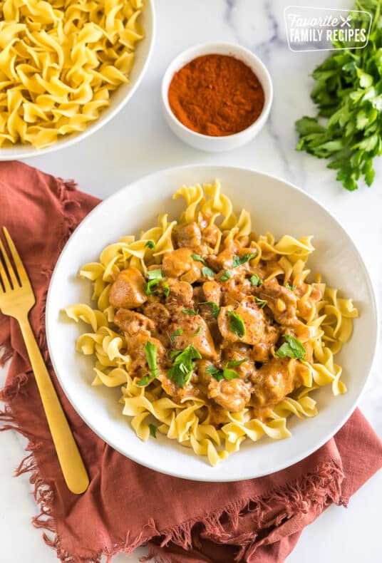 Chicken Paprikash in a bowl topped with parsley