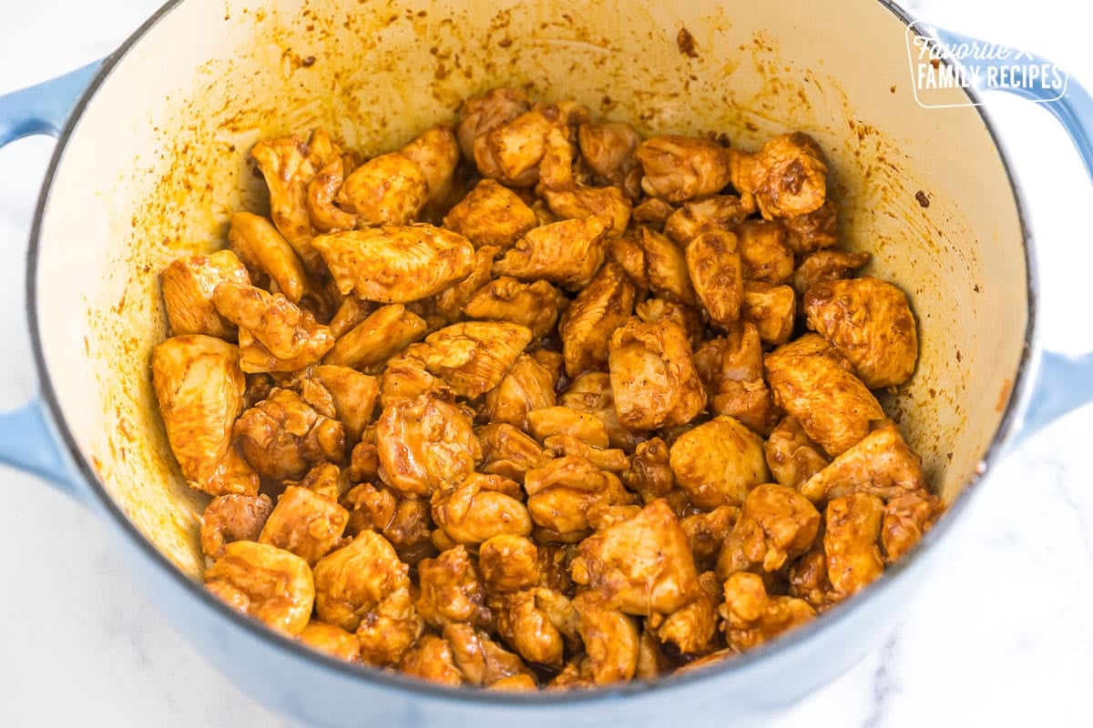 Pieces of chicken cooked in a large dutch oven