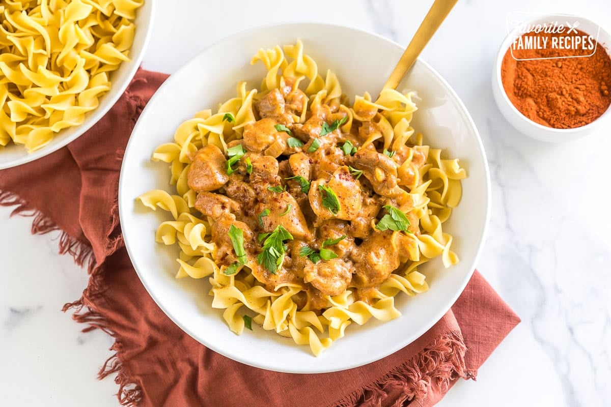 Chicken Paprikash in a bowl topped with parsley