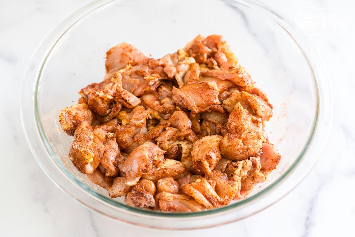 pieces of chicken tossed in flour and paprika