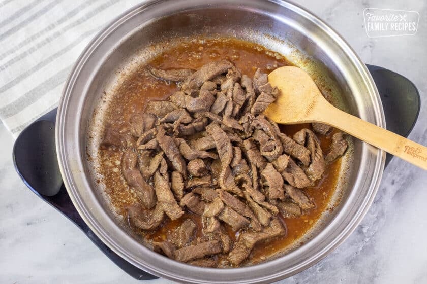 Marinaded beef cooking in a hot skillet for Stir Fry.