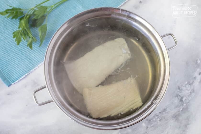 Cooking halibut in pan of water for Poor Man's Lobster.