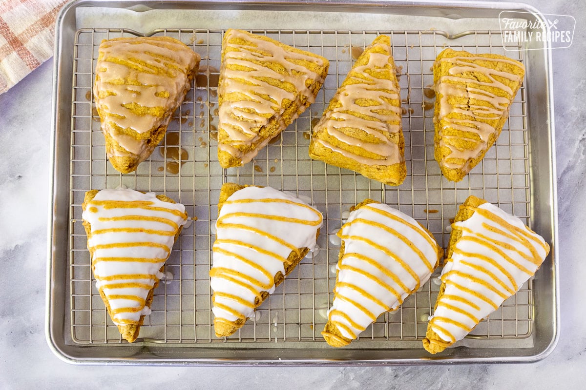 Cooling rack with Pumpkin scones with maple glaze and copycat Starbucks white and pumpkin glaze.