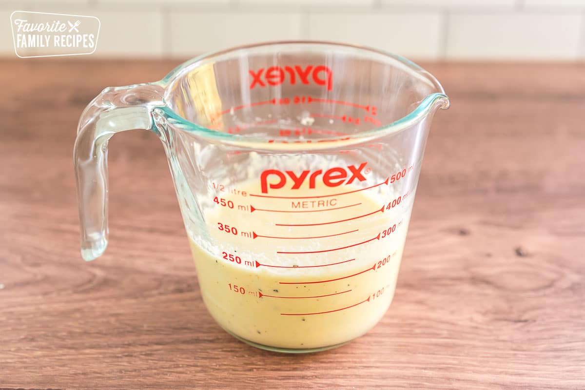 carbonara sauce in a glass measuring cup