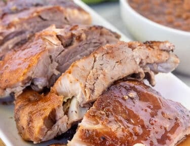 Crock Pot Ribs cut in small sections on a platter.