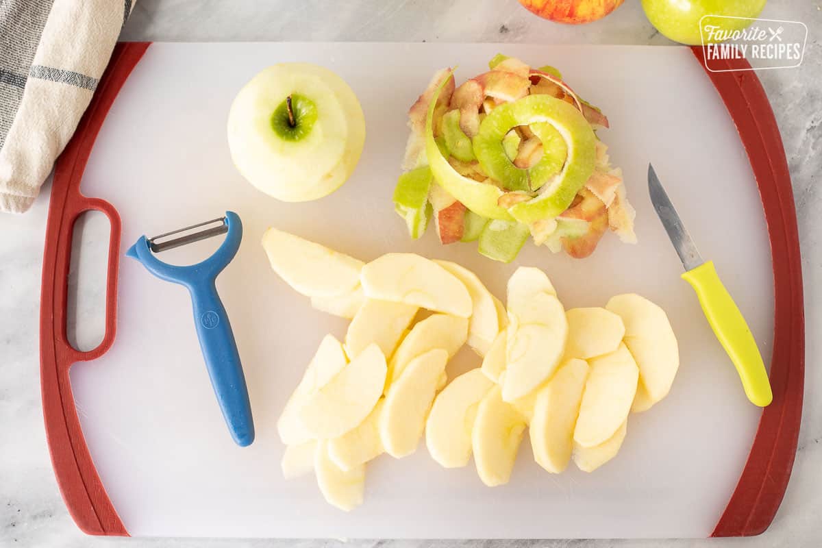 Cutting board with sliced apples for Apple Crisp.