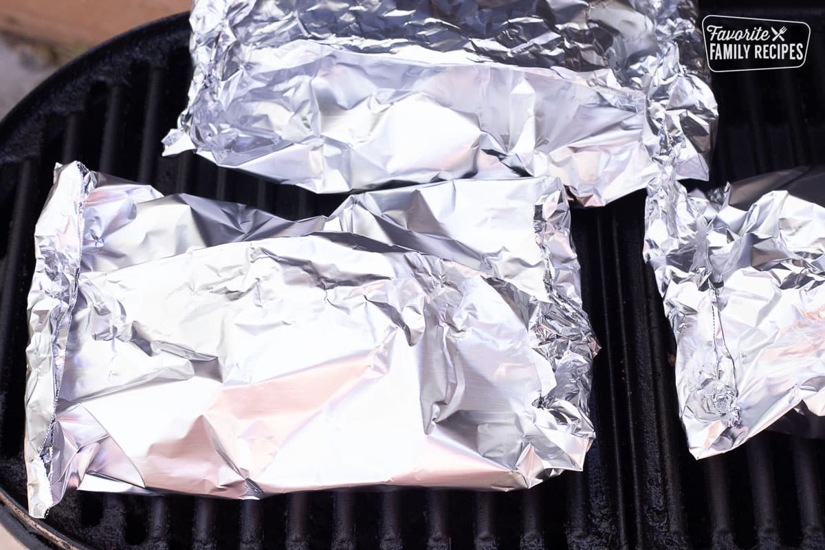 Foil packets on the BBQ grill filled with Ranch Potatoes.