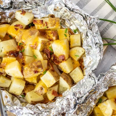 Grilled Ranch Potatoes in Foil topped with bacon, cheese and chives.