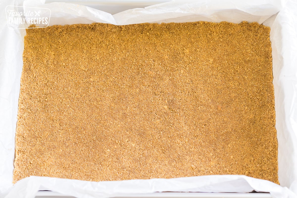 Graham cracker crust pressed into a baking sheet