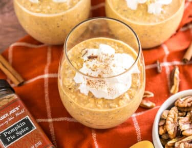 pumpkin overnight oats in a cup with whipped cream