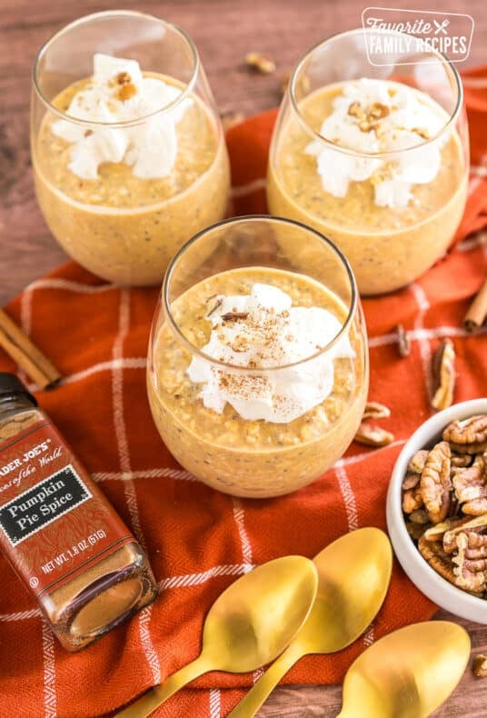 Pumpkin overnight oats in a cup with whipped cream.