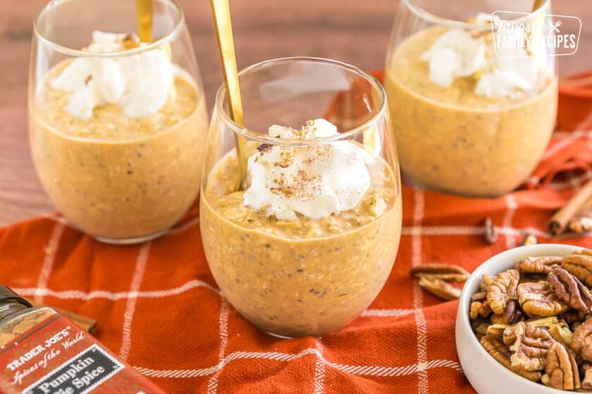 Pumpkin overnight oats in a cup with whipped cream.