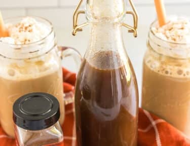 a tall glass bottle of pumpkin spice syrup