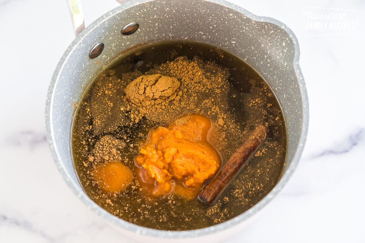 water, brown sugar, puree, and spices in a pot