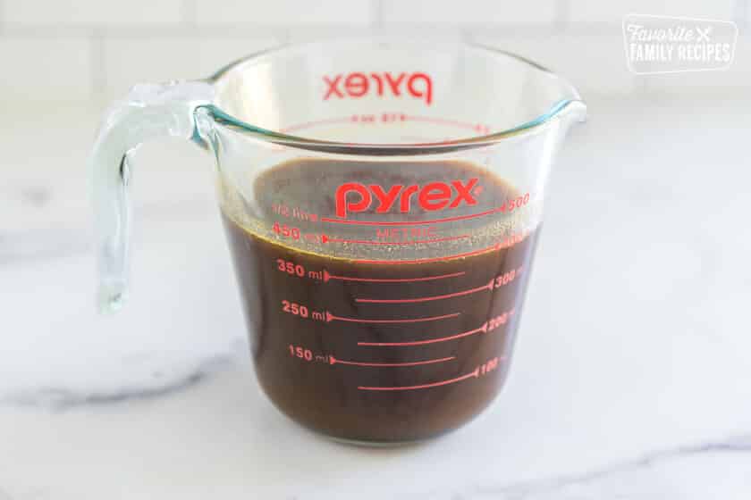 pumpkin spice syrup in a glass measuring cup