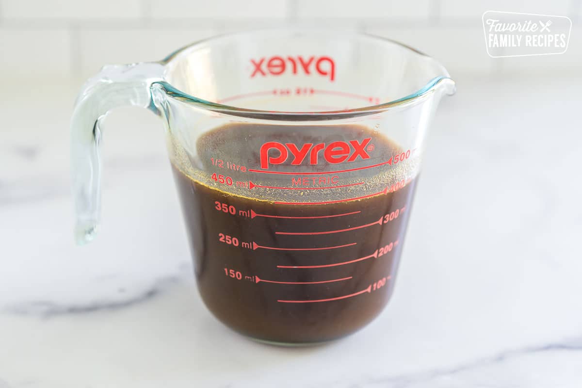 pumpkin spice syrup in a glass measuring cup