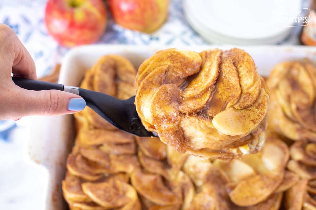 Spatula serving a piece of Caramel Apple French Toast Casserole.