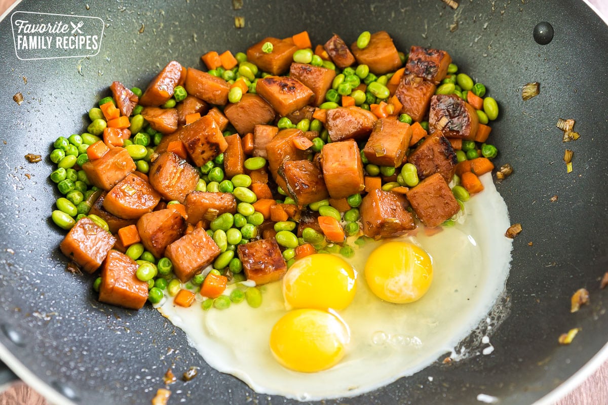 Spam, veggies, and eggs cooking in a wok
