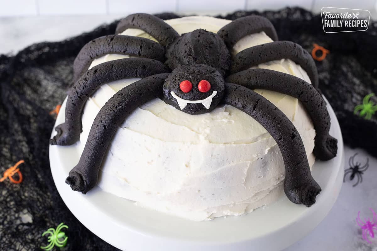 Spider Cake on a Cake stand with fang smile and Red Hot eyes.